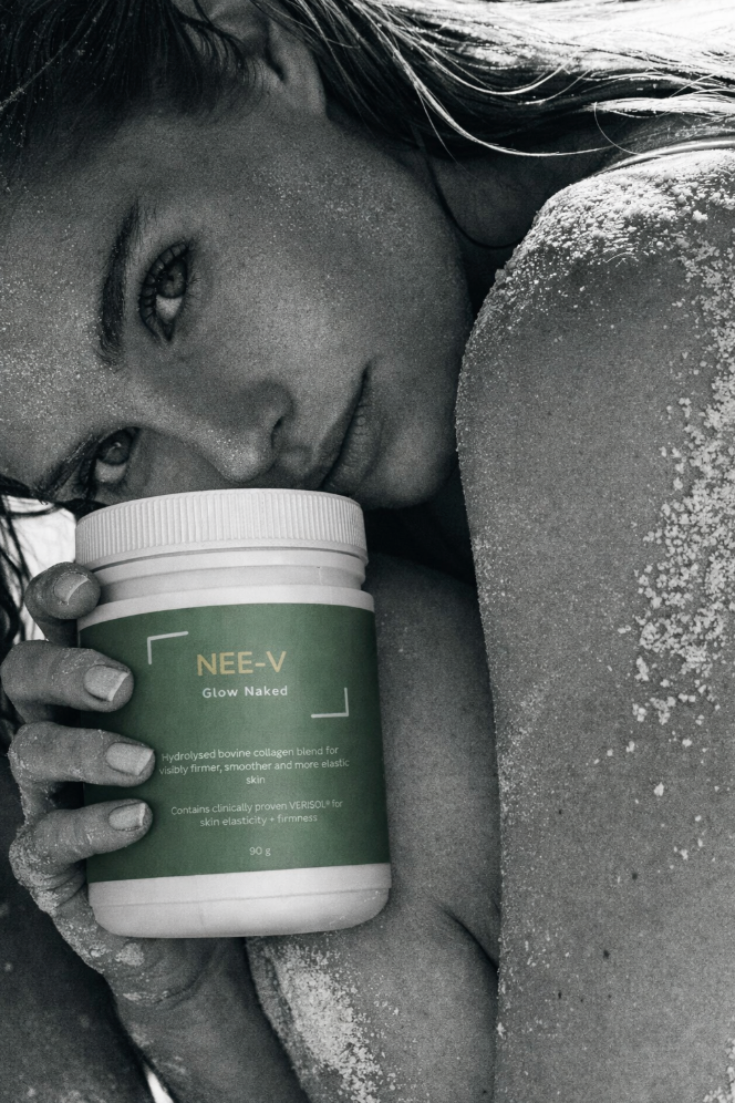 Person holding a container labeled 'NEE-V' in a close-up shot.