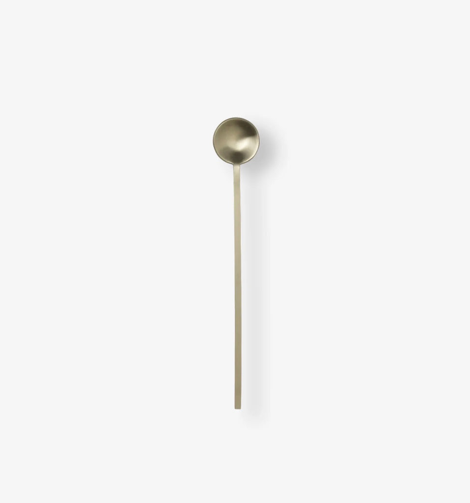 Antique gold measuring spoon used with NEE-V collagen supplements as part of a daily wellness ritual.